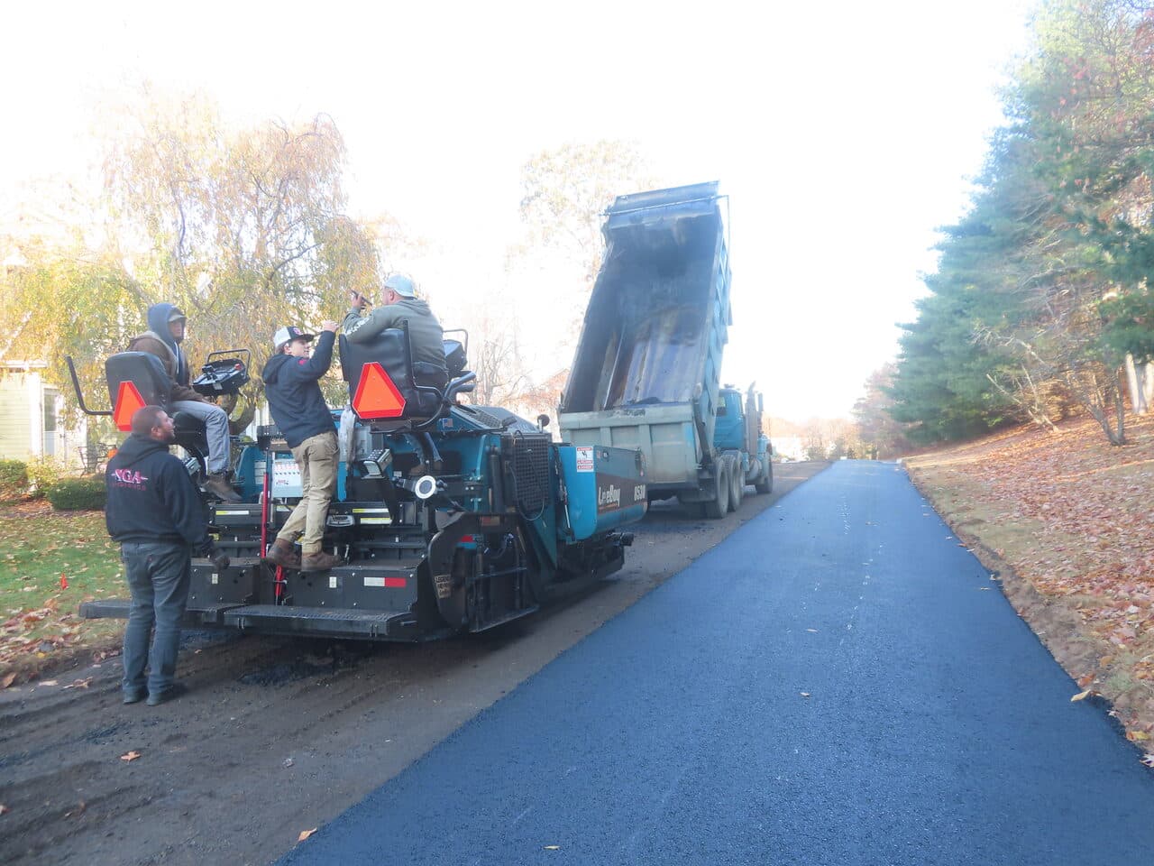 Roadway Paving project in Durham, CT — paving crew on paver and dump truck
