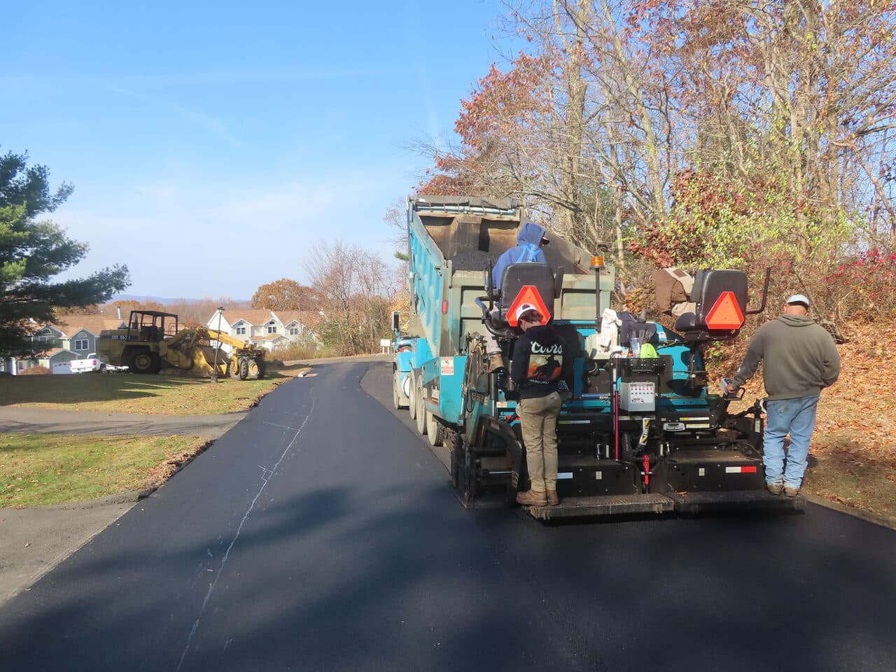 Roadway Paving project in Durham, CT — fresh paved driveway with paver crew