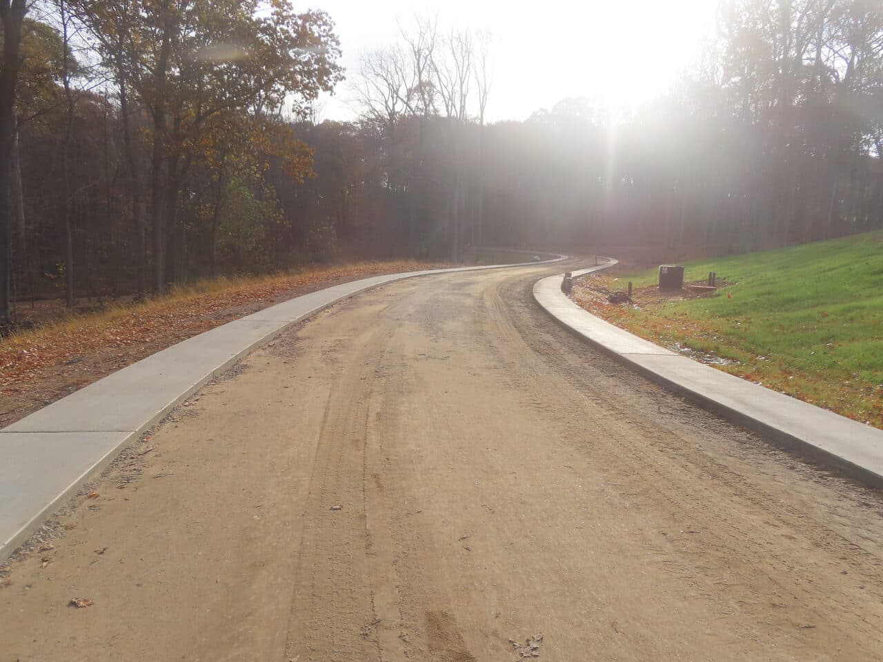 Golf Course Paving project in New Haven, CT — new concrete cart path curbs along dirt base