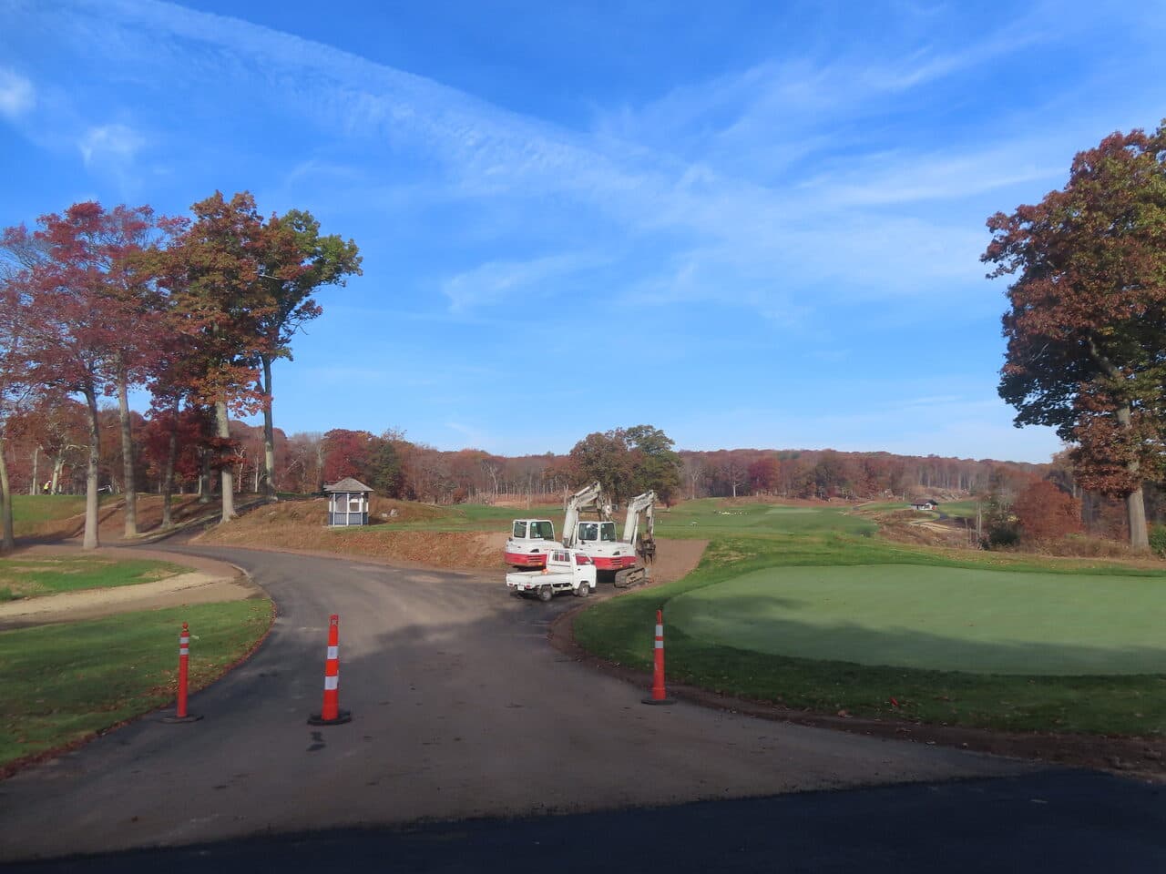 Golf Course Paving project in New Haven, CT — mini excavators staged near green