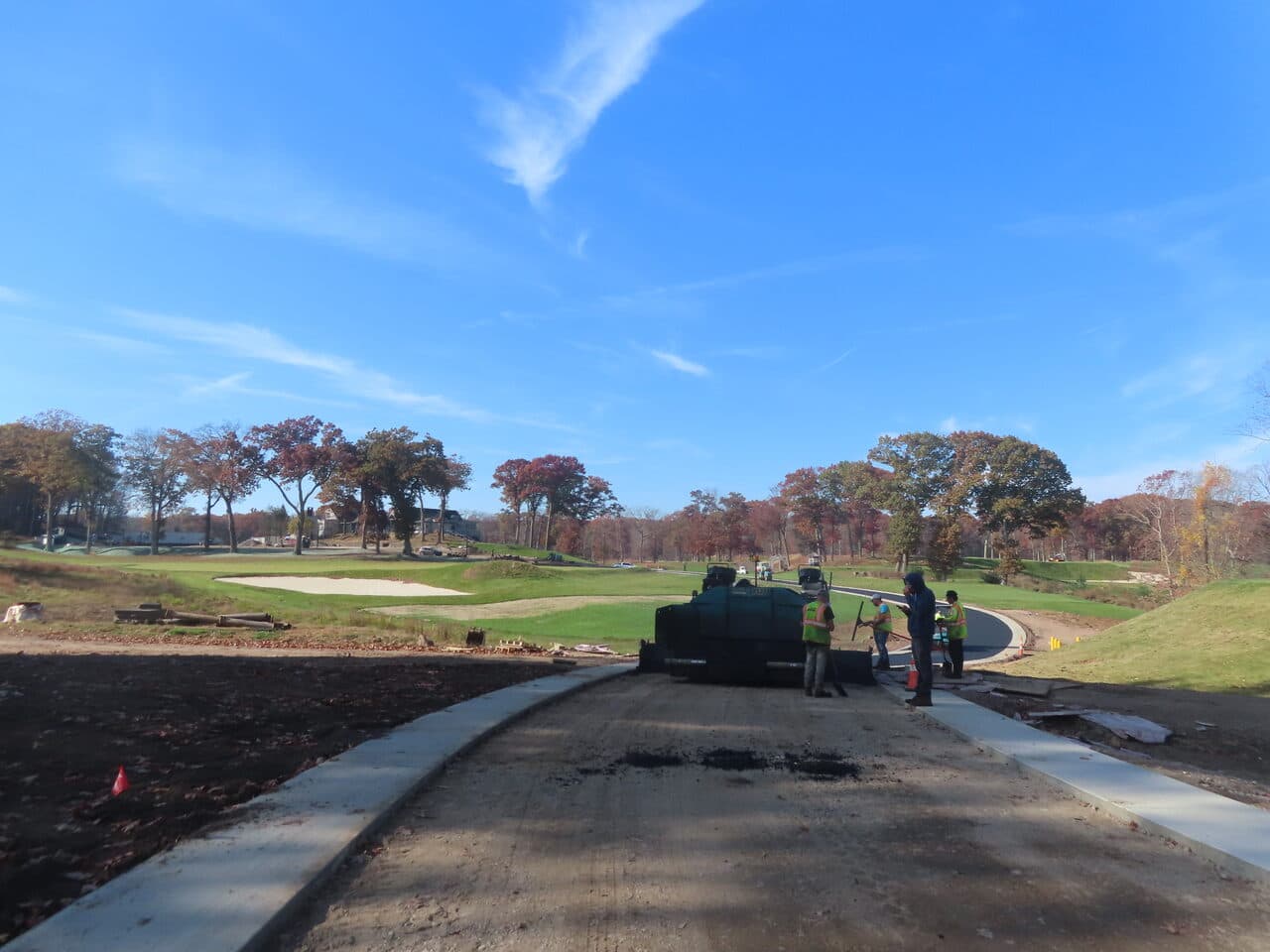 Golf Course Paving project in New Haven, CT — crew at paver placing asphalt path