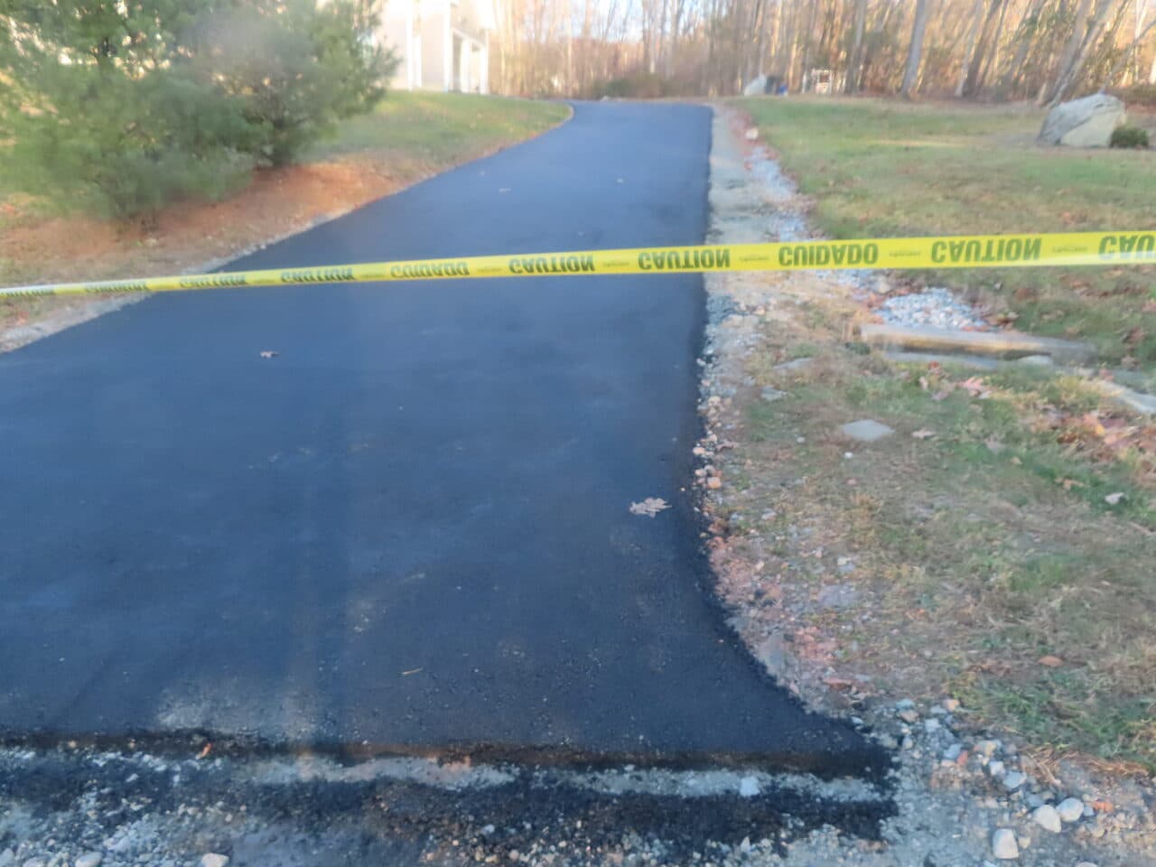 Residential Driveway Paving project in Middletown, CT — fresh driveway with caution tape