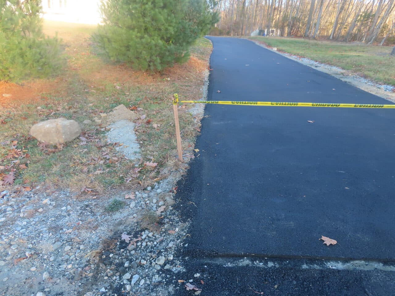 Residential Driveway Paving project in Middletown, CT — driveway edge detail with caution tape