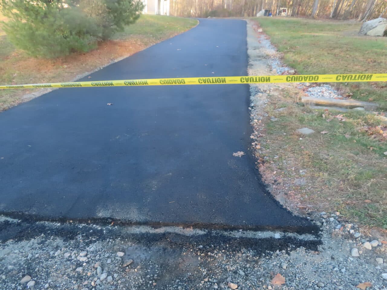 Residential Driveway Paving project in Middletown, CT — fresh driveway edge with caution tape