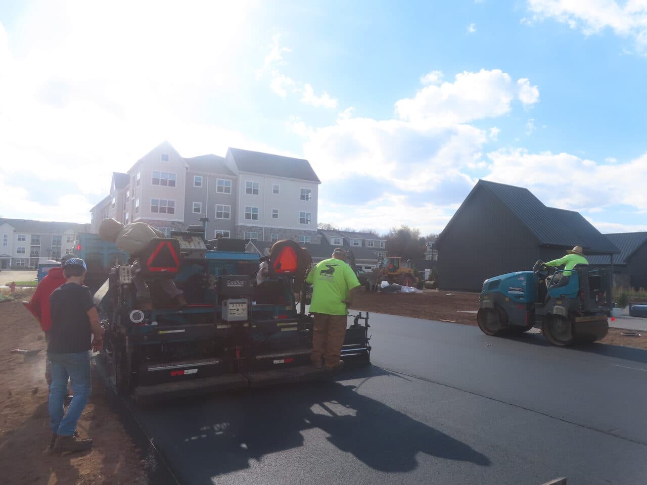 Commercial Apartment Complex Parking Lot Paving project in Middletown, CT — crew operating paver at apartment lot