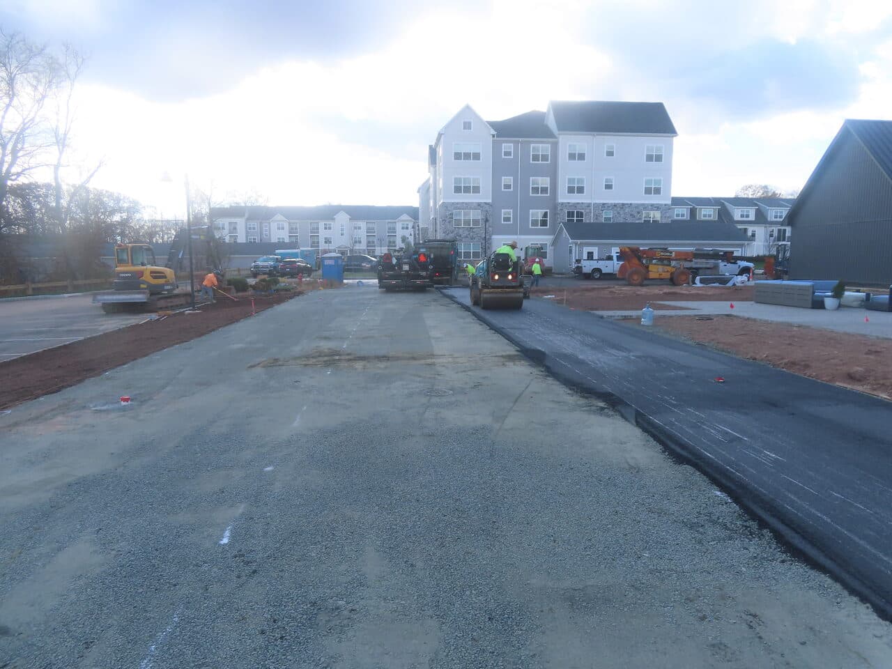 Commercial Apartment Complex Parking Lot Paving project in Middletown, CT — rolling asphalt over base at complex
