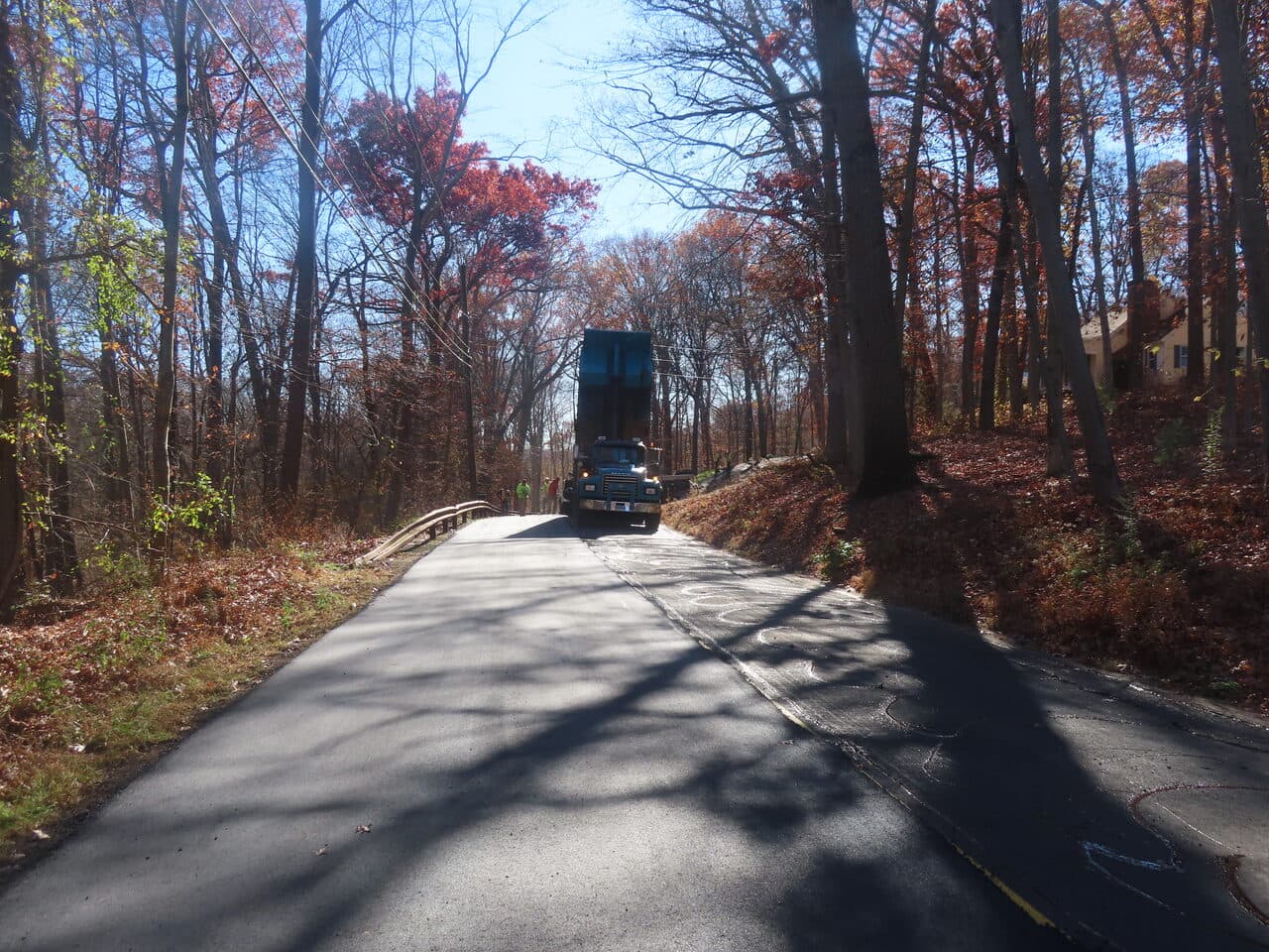 Roadway Paving project in Northford, CT — fresh paved road with paver truck