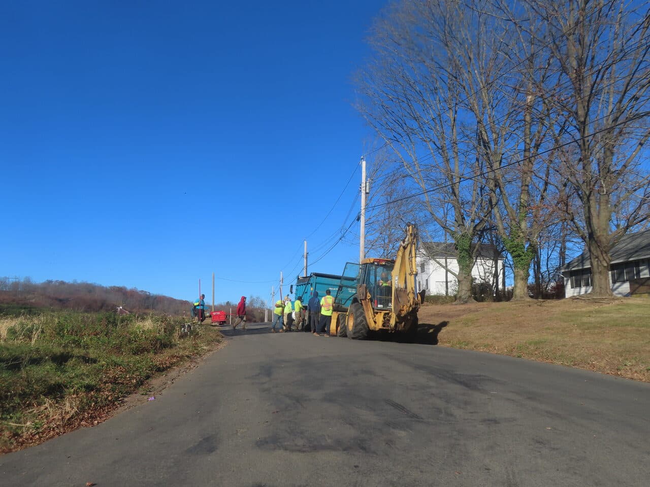 Roadway Paving project in Northford, CT — backhoe and crew on rural road