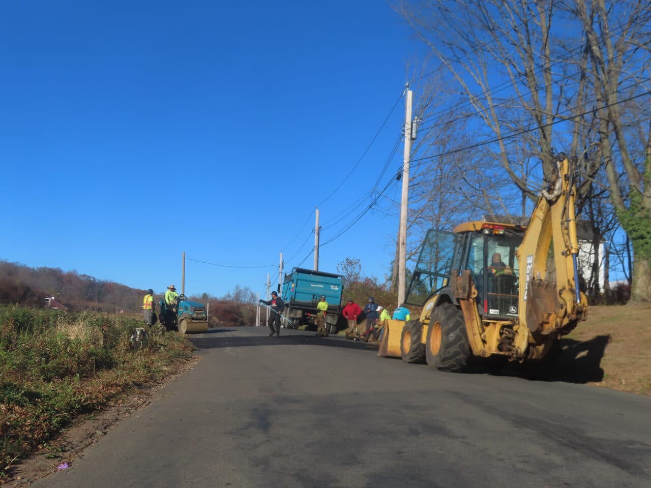 Roadway Paving project in Northford, CT — backhoe roller crew rural road work