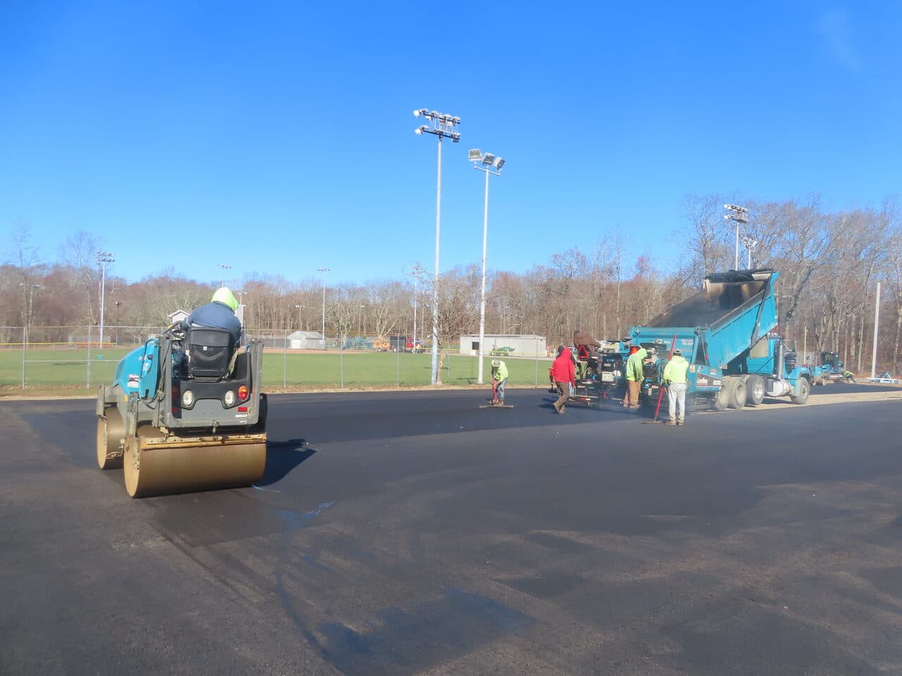 Commercial Parking Lot Paving project in Montville, CT — roller and crew compacting new lot