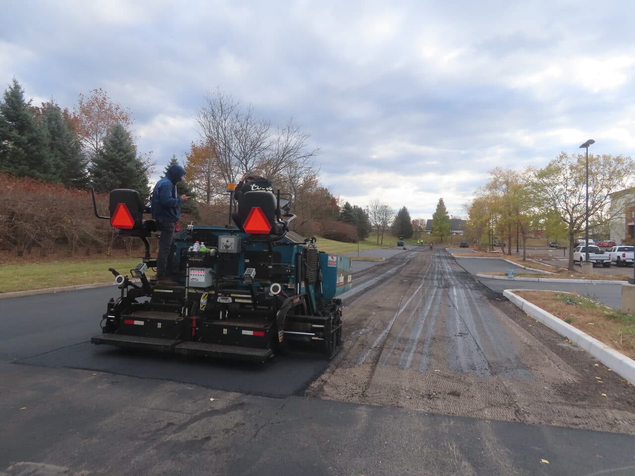 Commercial Parking Lot Paving project in South Windsor, CT — paver on fresh asphalt lane