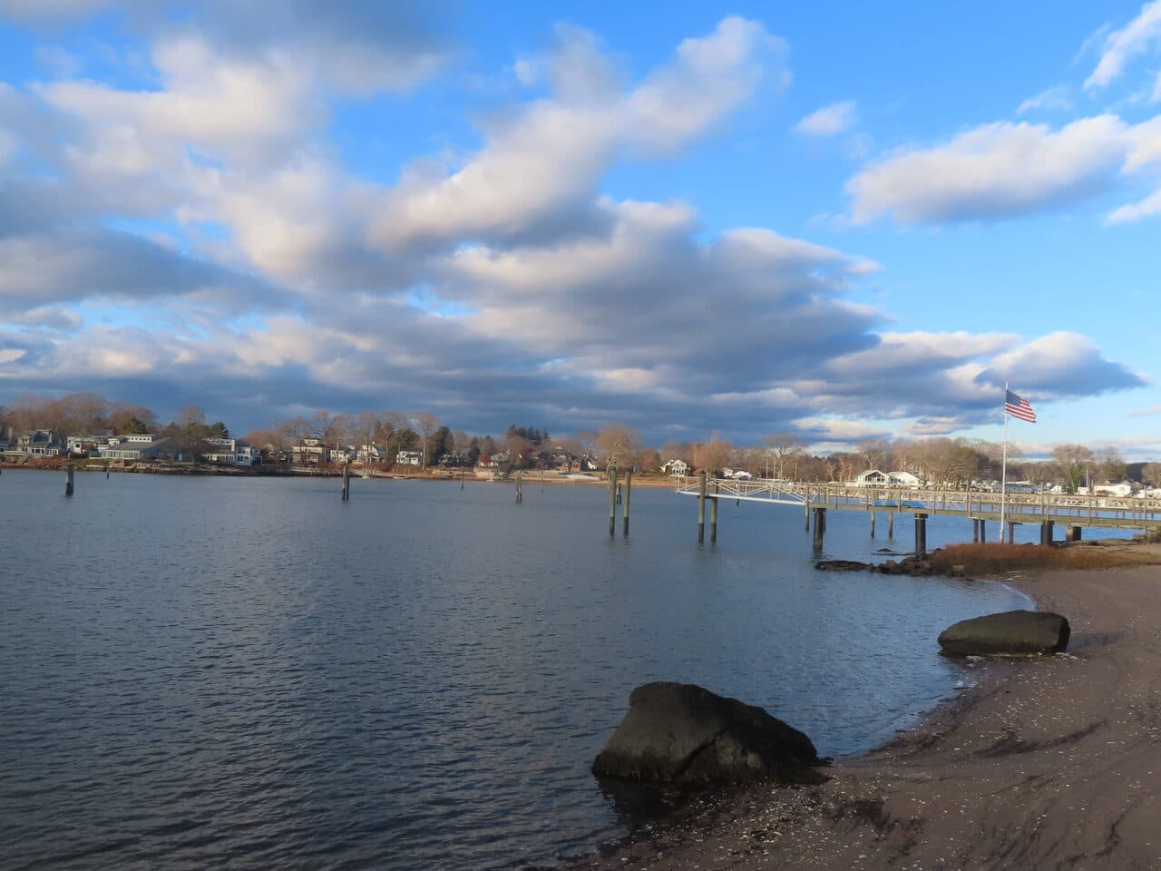 Roadway Paving project in Branford, CT — harbor view with dock and flag