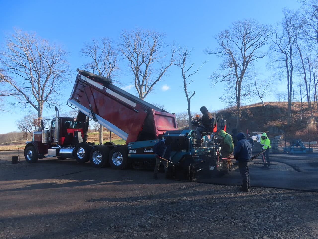 Golf Course Paving project in New Haven, CT — dump truck feeding paver crew