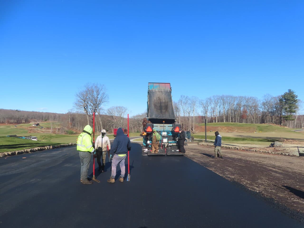 Golf Course Paving project in New Haven, CT — paving crew behind paver on road