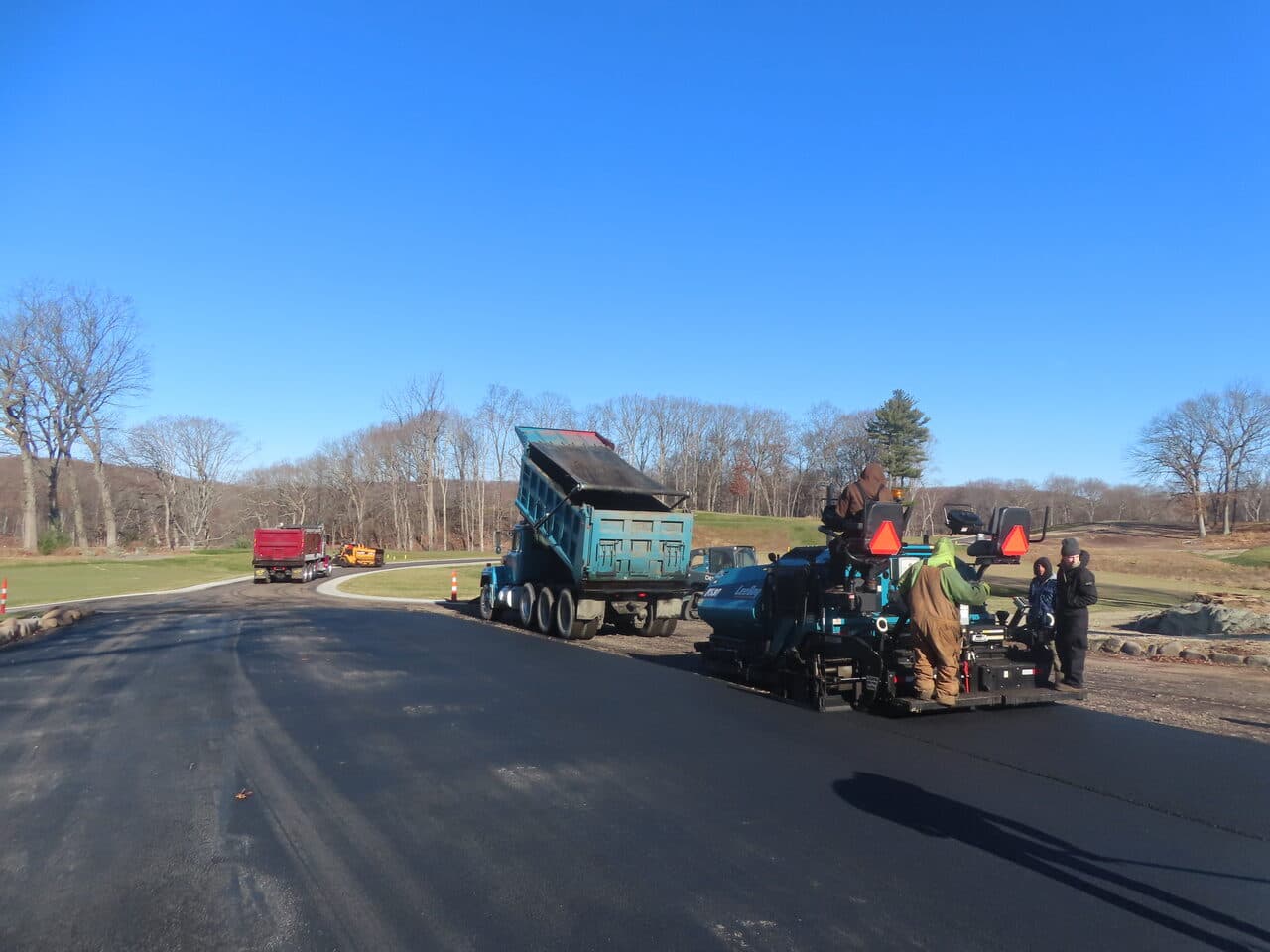 Golf Course Paving project in New Haven, CT — paver laying asphalt on roadway
