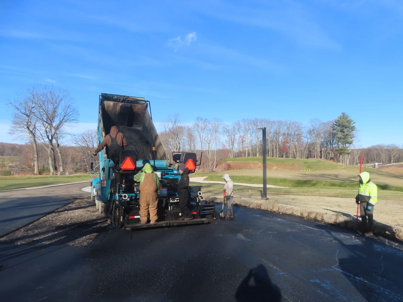 Golf Course Paving project in New Haven, CT — dump truck loading paver hopper
