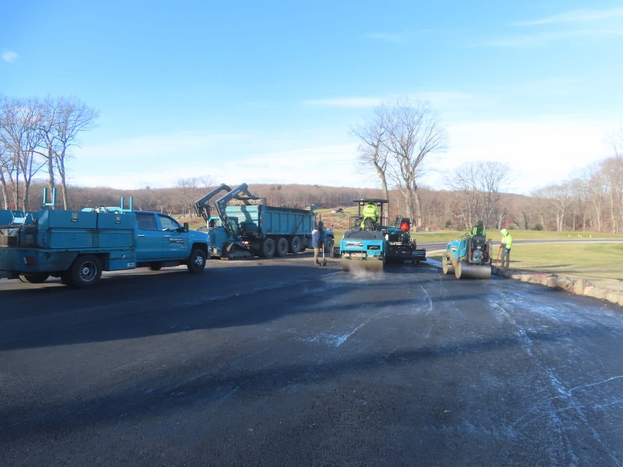 Golf Course Paving project in New Haven, CT — roller and paver compacting new lot