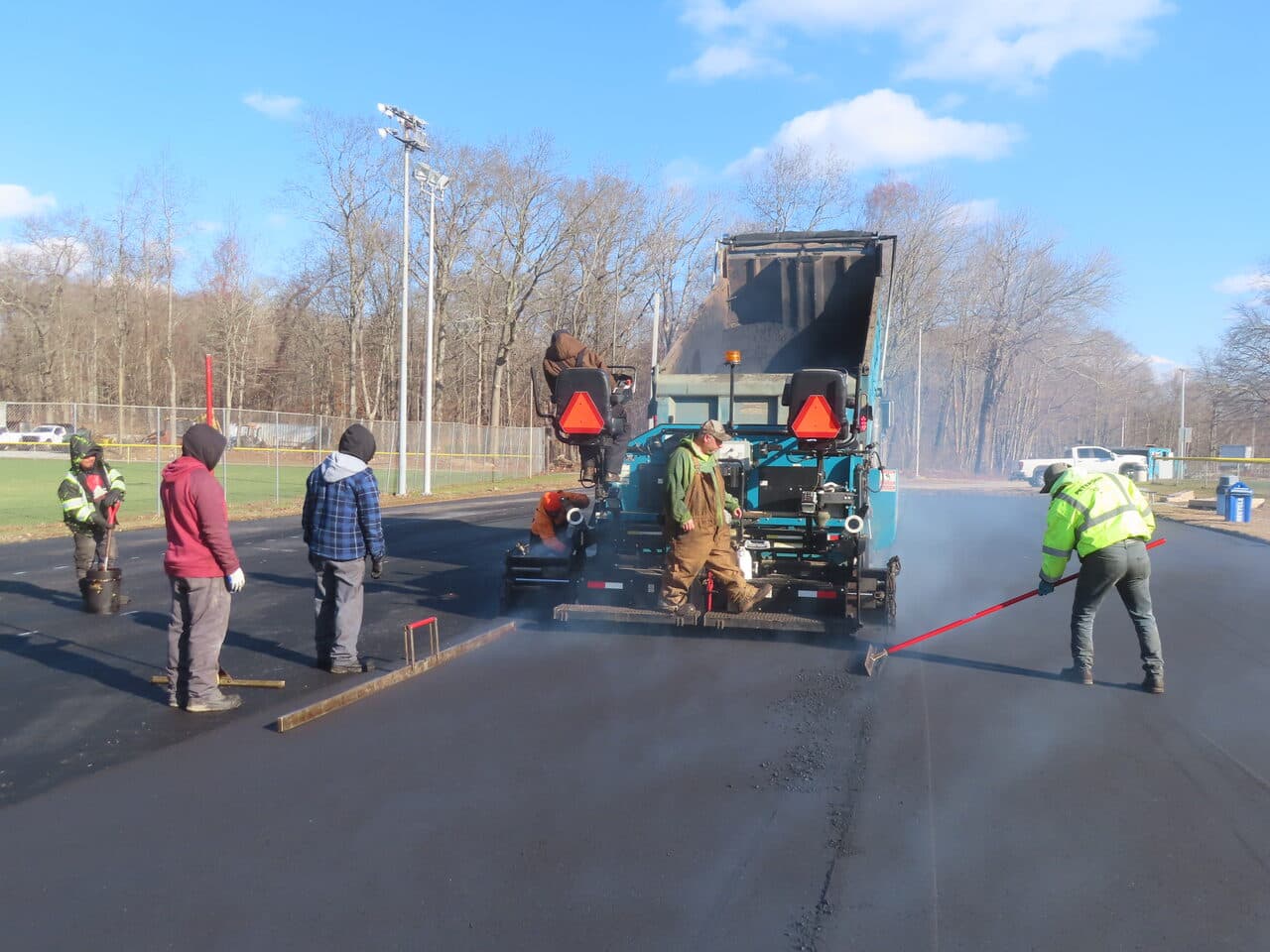 Commercial Parking Lot Paving project in Montville, CT — paver laying hot asphalt