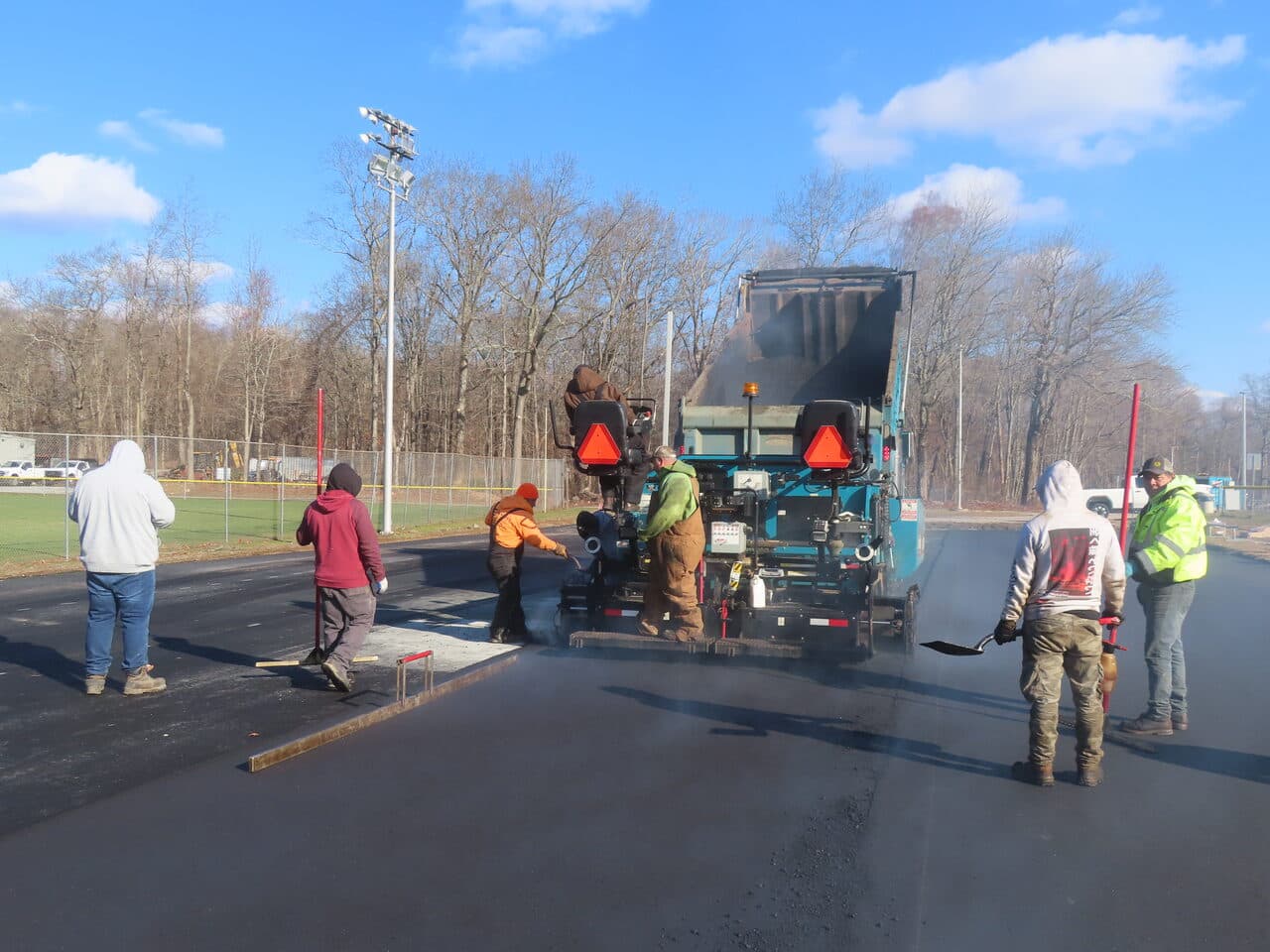 Commercial Parking Lot Paving project in Montville, CT — paving crew with paver machine