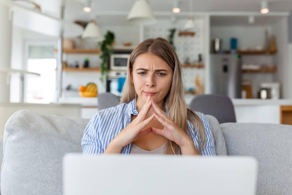 Concerned woman looking at a scam email