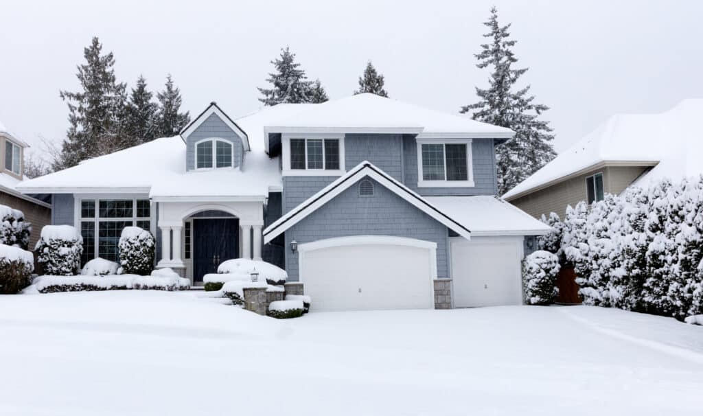 Front view of falling snow with home during rare storm in United States