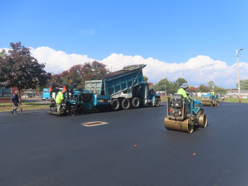 Asphalt paving crew resurfacing a roadway in West Haven, Connecticut using professional paving equipment