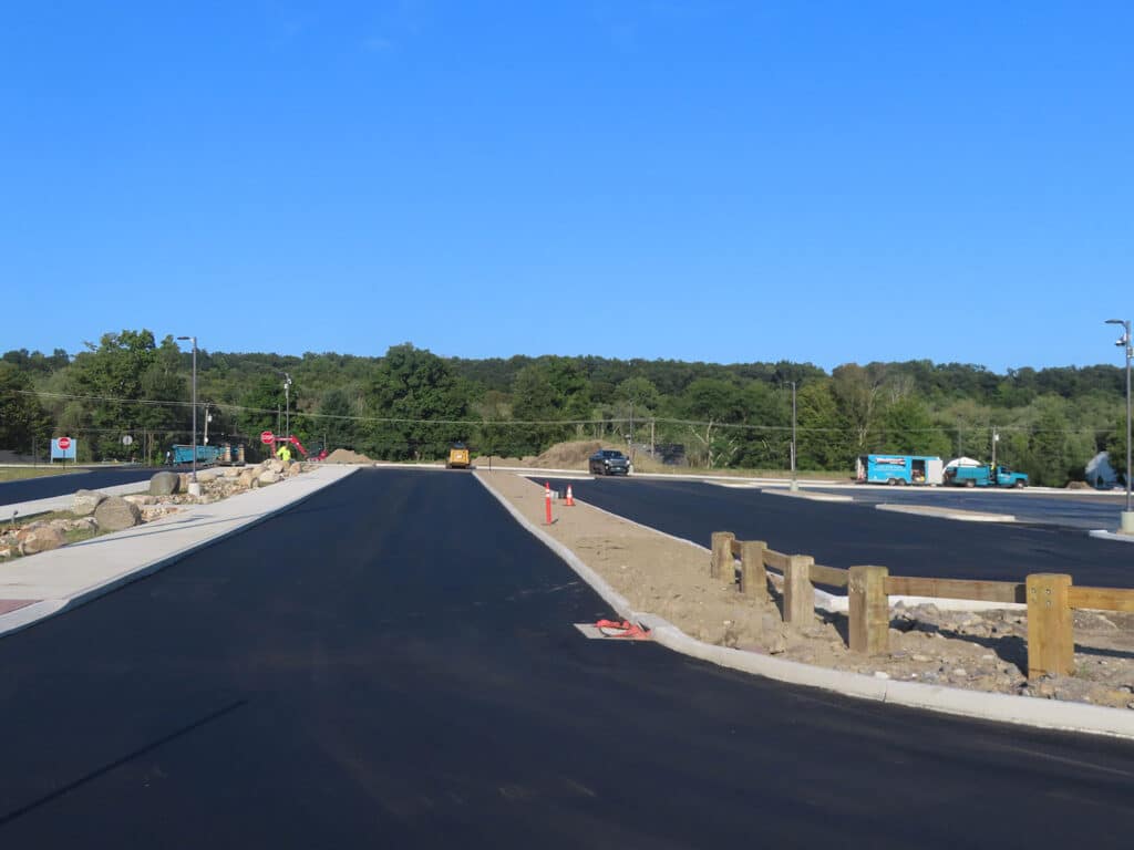 Asphalt paving project in Danbury, CT featuring newly paved roadway and parking lot by Maisano Bros.