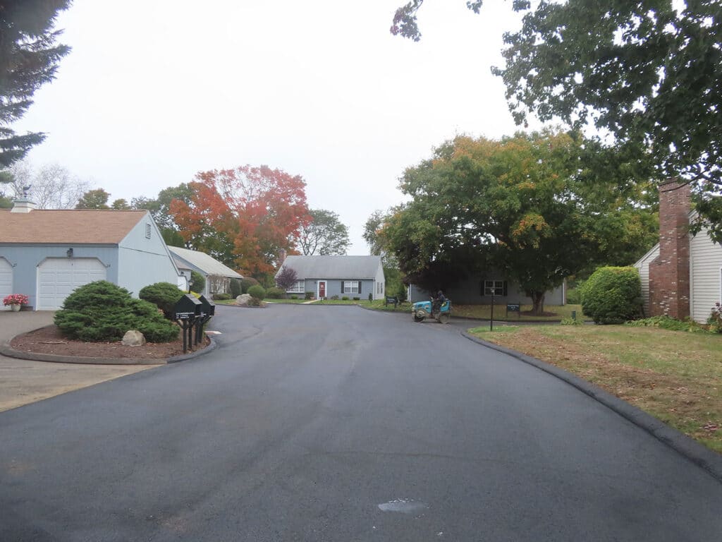 Freshly paved residential asphalt roadway in a Madison, Connecticut neighborhood