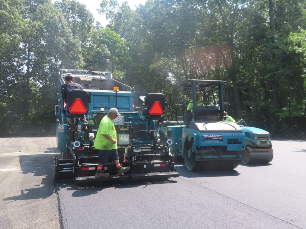 Maisano Bros. paving crew installing fresh asphalt on a roadway in Springfield, Massachusetts