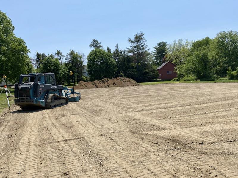 Asphalt grading and base preparation using skid steer before paving